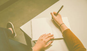 woman writing in the notebook